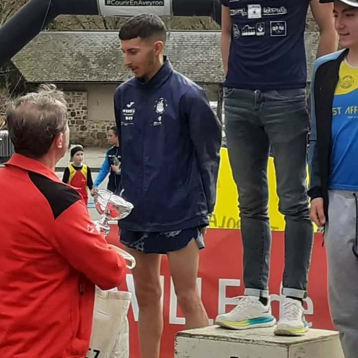 Ludovic Delpuech sur le podium avec trophée, Courir en Aveyron